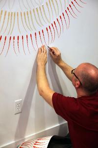 Curtis installing his work